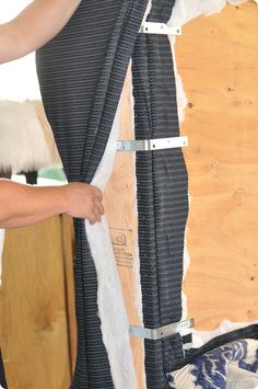 a person is working on a piece of furniture that has been stripped off with tape