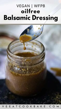 a spoon full of balsamico dressing in a jar