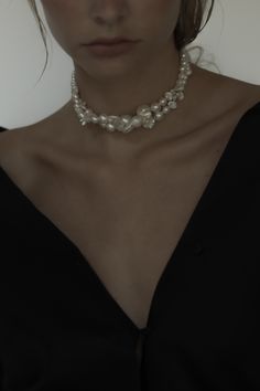 A bold necklace // adds an eye-catching accessory that needs nothing more. The Baroque Wavering Necklace is a myriad of pearls, including freshwater + Swarovski, intertwine to create a wildly elegant choker— finished with ivory velvet ties. Feeling forward? #datenight #antibride #modern #rtw #everydaystyle #necklace #pearl #pearlnecklace #datenightinspo #weddingday #weddingstyle #bridalinspo #modernbride