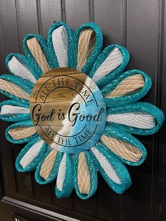 a blue and white sunflower with the words god is good on it's side