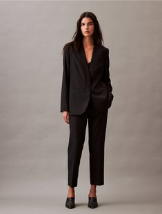 Tailored in a slim fit, these Calvin Klein suit pants are wrinkle-resistant and crafted with 4-way stretch for ease of movement. Detailed with an interior hook clasp and slip pockets in a clean, modern silhouette. Style with a blazer for a sharp outfit fitted for the office or special occasions.  Material: 66% Polyester, 31% Viscose, 3% Elastane.