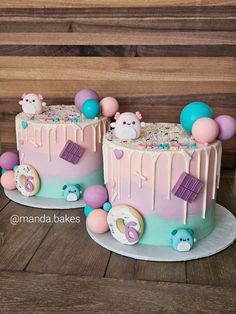 two cakes decorated with pastel icing and decorations