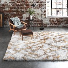 a living room with brick walls and an area rug that has been made to look like it