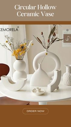 a white table topped with vases filled with flowers