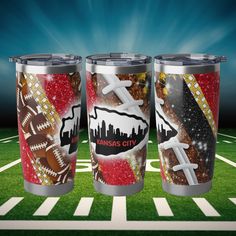 three travel mugs on a football field with the kansas city skyline