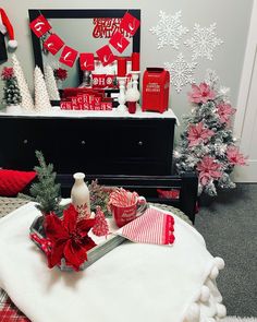 a room decorated for christmas with red and white decorations