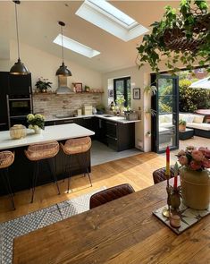 an open kitchen and dining room with wooden floors