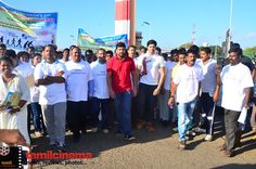 a group of people standing around each other in front of a sign that reads,