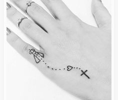 a person's hand with a tattoo on it and a cross in the middle