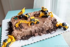 a birthday cake with construction vehicles on it