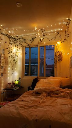 a bedroom with lights strung from the ceiling