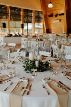 the tables are set with silverware and place settings