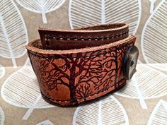 Leather Cuff Bracelet Wrap, Tree Silhouette Print in Brown & Sienna, Adjustable Size Distressed Brown Leather Bracelet Gift, Adjustable Brown Cuff Bracelet, Unique Brown Cuff Bracelet, Brown Cuff Bracelet With Wrist Strap, Unique Brown Cuff Bracelets, Hand Tooled Brown Cuff Bracelet, Rustic Brown Cuff Bracelet As Gift, Rustic Brown Cuff Bracelet Gift, Handmade Brown Cuff Bracelets