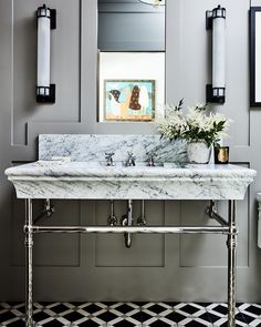 a bathroom sink sitting under a mirror next to a wall mounted faucet with lights on it