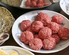 there are many different types of meatballs on the plate and in bowls next to each other