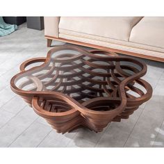 a coffee table made out of wood and glass with an intricate design on the top