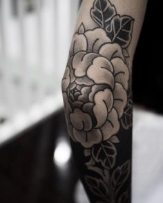 a person with a flower tattoo on their arm