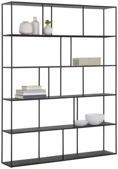 a black shelf with two white vases and some books on the top one is empty