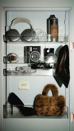 the shelves have various items on them including shoes and handbags