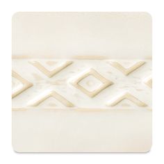 a close up of a white tile with geometric designs on the bottom and center part