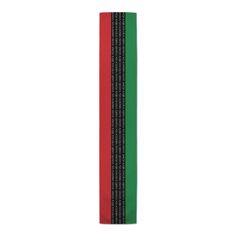 a red, green and black striped bookmark on a white background