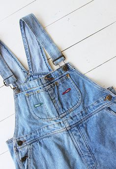 Vintage denim dungaree shorts in pale blue Single chest pocket and double waist pockets front and back. UK 6 / Eur 34. Measurements - 32" waist - 36" hips - 7" inner leg. Material - Denim. Condition - Excellent. Handpicked, repaired and ready to wear. This is an original vintage item, not new and minor signs of wear & age are expected, we will highlight any major flaws. Model is a UK 8 and is 5'6" tall. Vintage Light Wash Overalls With Pockets, Denim Overalls With Pockets In Short Length, Denim Overalls With Pockets Short Length, Short Denim Overalls With Pockets, Denim Blue Shortalls With Pockets, Medium Wash Short Length Overalls With Pockets, Short Length Medium Wash Overalls With Pockets, Cotton Cutoff Shortalls With Pockets, Vintage Denim Blue Jean Shorts With Pockets