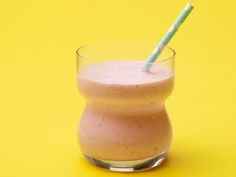 a pink smoothie in a glass with a straw