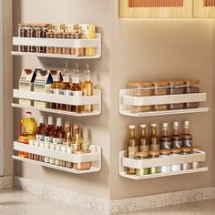 three white shelves filled with spices and condiments