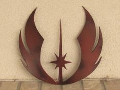 a metal star and crescent design on the side of a building with brick flooring