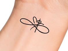 a black ink tattoo on the wrist of a woman's arm with an infinite symbol