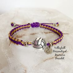 a purple and gold beaded bracelet with a volleyball charm