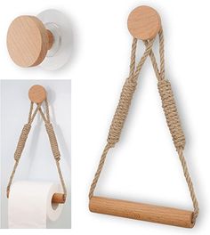 a wooden object with rope hanging from it's sides and two rolls of toilet paper on the other side