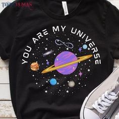 a black shirt with the words you are my universe on it next to a pair of sneakers