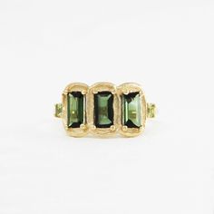 three stone ring in yellow gold with green tourmaline stones