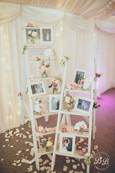 a wedding photo display with flowers and pictures on it