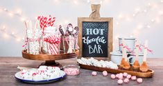 an assortment of candy and candies on a table with a sign that says hot chocolate bar