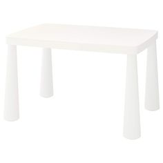 a white table sitting on top of a white floor