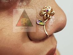 a close up of a person's nose with a gold nose ring on it