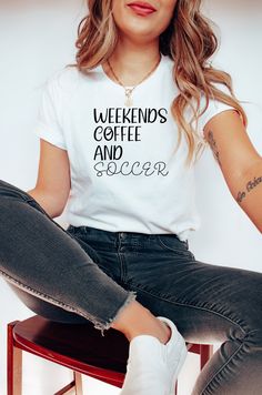 a woman sitting on top of a stool wearing a t - shirt that says coffee makes me feel alive