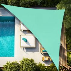 an aerial view of a swimming pool and patio area with shade sail over the pool