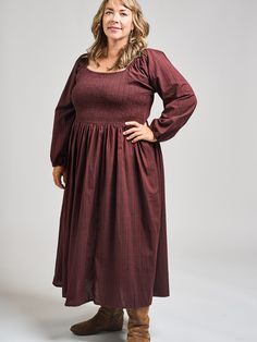 This is a modified version of our Teddy Midi dress, with long sleeves for chillier days. This midi dress features pretty sleeves, an elastic bodice with a flattering fit, and hidden pockets. Cut from a rich, yarn-dyed maroon cotton, this subtle print is a stunner. 100% Cotton Small-batch yarn dyed fabric Hidden pockets Elasticated bodice Length from center front of size 2X is 46" Made fair trade in India by one of our longstanding production partners Fall Knee-length Dress With Smocked Bodice, Daywear Midi Dress With Smocked Cuffs, Midi Smocked Dress For Gatherings, Daywear Midi-length Dresses With Smocked Cuffs, Daywear Midi Length Dress With Smocked Cuffs, Modest Daywear Dresses With Smocked Cuffs, Fall Square Neck Dress With Smocked Back, Fall Midi Dress With Gathered Bishop Sleeves, Daywear Midi-length Smocked Maxi Dress