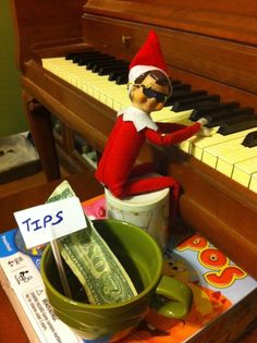 an elf is playing the piano with money