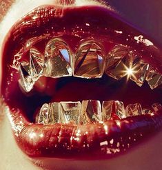 a woman's mouth with shiny teeth and red lipstick