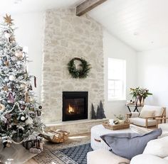 a living room with a christmas tree in the corner and presents on the fireplace mantel