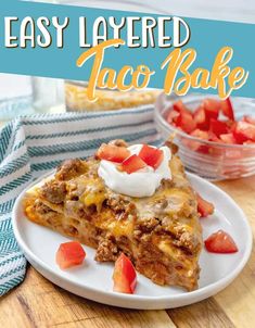 easy layered taco bake on a white plate with strawberries and sour cream