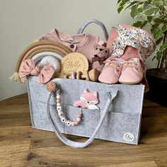 Beautifully presented Newborn essentials in a grey felt nappy organiser (optional ) The Ultimate Baby Hamper includes: - Nappy caddy( Nappy box) - optional - Baby romper size 3-6  months - An engraved wooden "Hello world" disk. - Personalised Clip   - Pink Fox or wooden elephant  - Booties (0-6 months) - vintage flower blanket with ears (120cm x 120cm ) - Teddy Bear  - Wooden rattle - 2x cable knit headband. It's made out of soft nylon and looks very adorable and super cute - Wall hanging rainbo Nappy Organiser, Nappy Caddy, Baby Girl Gift Basket, Rainbow Tapestry, Newborn Gift Boxes, Girl Gift Baskets, Cable Knit Headband, Baby Gift Hampers, Cadeau Baby Shower