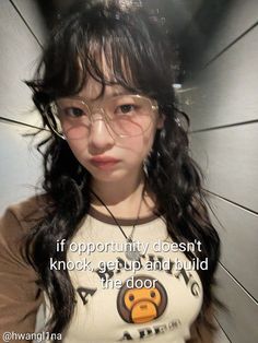 a girl with glasses holding an umbrella in front of her face and the caption if opportunity doesn't knock, get up and build the door