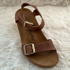 Birkenstock Papillio Soley Wedge Sandals Cognac Brown Nubuck Leather 36n Size 5-5.5 Nar-Med New In Box (Box Damaged) The Soley Is A Classic Wedge Heel Sandal From Papillio. The Soley Is The Perfect Combination Of Style And Comfort, With Its Simple Design And Sleek Heel Strap. The Upper Is Made From High-Quality, Soft Natural Leather. Polyurethane Footbed Upper: Natural Leather Footbed Lining: Suede Sole: Polyurethane (Pu) 2 1/2" Heel; 1" Platform Details: Two Straps, Each With An Individually Ad Casual Low Heel Wedge Sandals For Vacation, Casual Leather Wedge Sandals With Low Heel, Brown Wedge Sandals With Cushioned Footbed And Flat Heel, Brown Flat Heel Wedge Sandals With Cushioned Footbed, Casual Low Heel Wedge Sandals With Buckle, Casual Low Heel Wedge Sandals With Buckle Closure, Leather Wedge Sandals With Round Toe For Everyday, Beach Wedge Sandals With Heel Strap And Low Heel, Everyday Leather Wedge Sandals