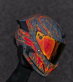 a motorcycle helmet with flames painted on it's face and the visor partially closed