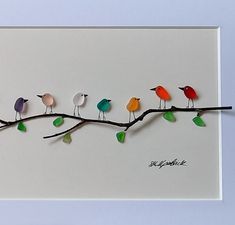 a group of birds sitting on top of a tree branch